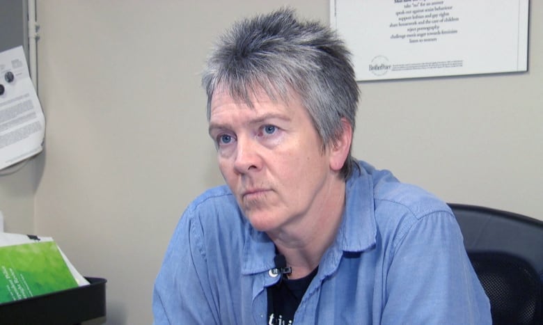 A woman sitting at a desk.