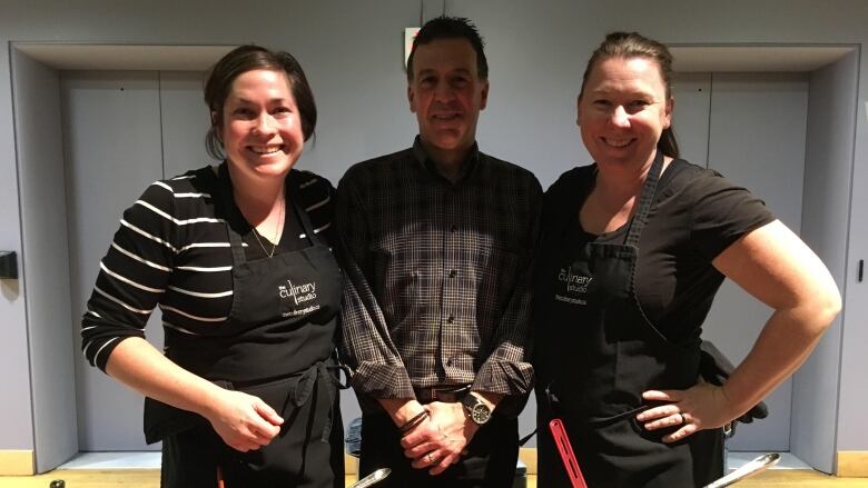 Two female chefs pose with food columnist Andrew Coppolino