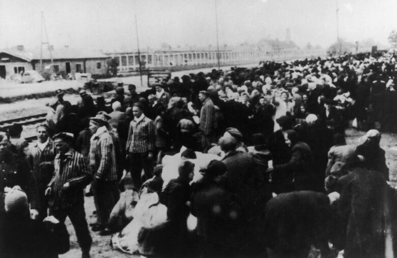 Lines of Jews waiting to board a train at a Nazi concentration camp.