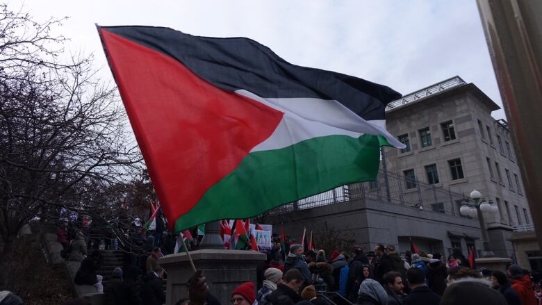 A Palestinian flag flies in front of the U.S. Embassy