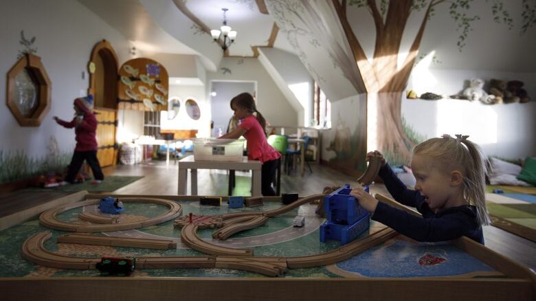 Kids play at Fable Child Care Centre in Morinville, Alta. It's a fantastical structure with a wavy roof, curved wooden doors and - as Chauvet's story goes - a chimney squashed by a giant.