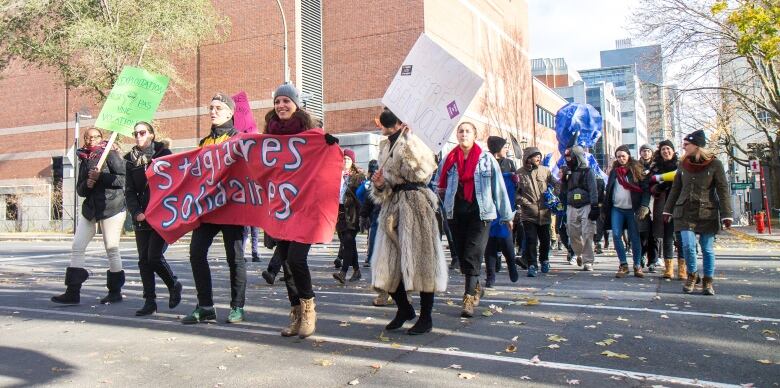 people protesting for paid internships