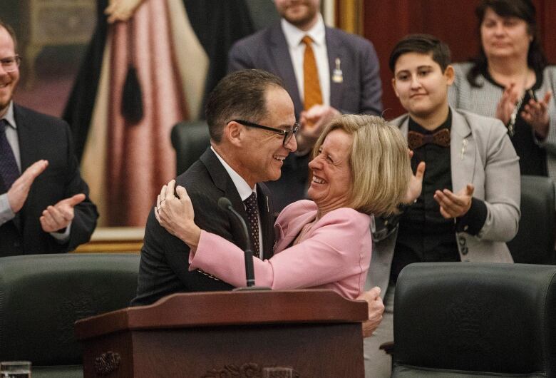 The finance minister and premier embrace after the budget speech in 2018.