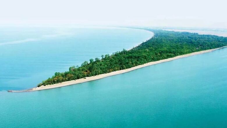 An aerial view of Point Pelee and the light blue water. 