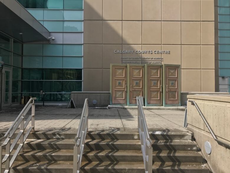 a building is pictured with a sign that reads Calgary Courts Centre.