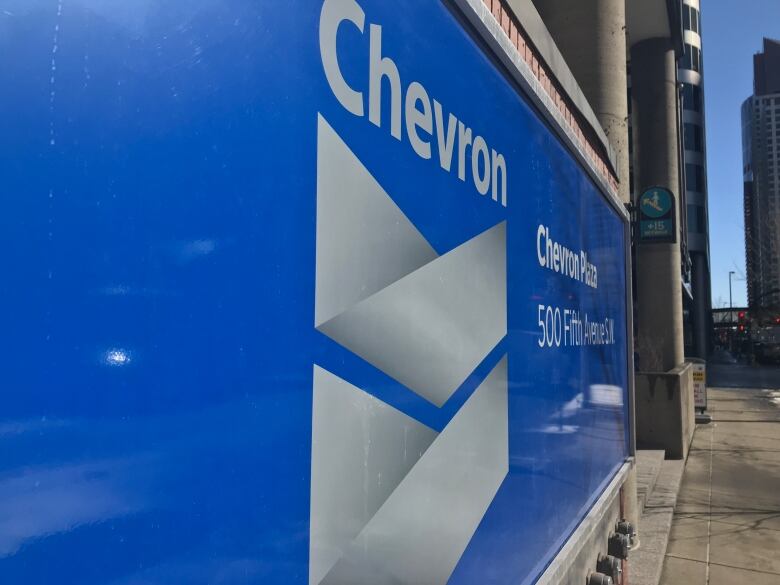 A blue sign with a chevron on it says Chevron.