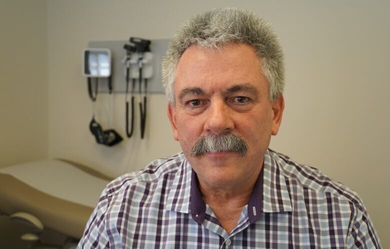 A man in a doctor's examination room.