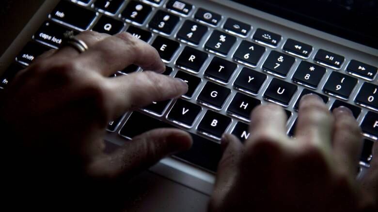 A person types on a keyboard. 