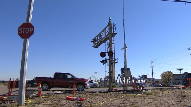 A road with some lights and a truck at the spot where the overpass will be built.