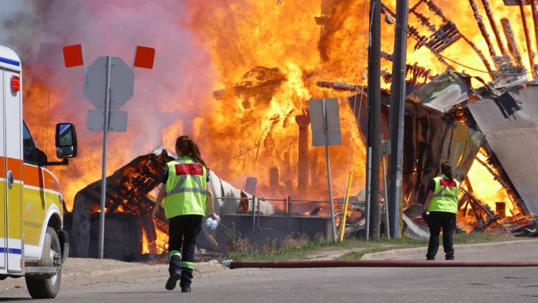 Flames shoot out of a building.