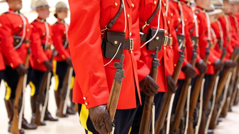 Royal Canadian Mounted Police (RCMP) cadets await badge presentations at a graduation ceremony at the RCMP Academy in Regina on June 5, 2017.