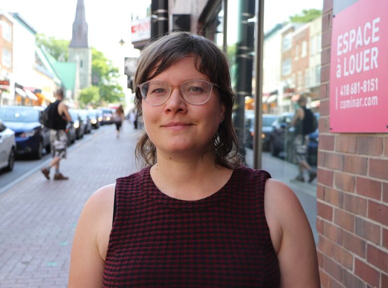 woman with glasses looking at camera