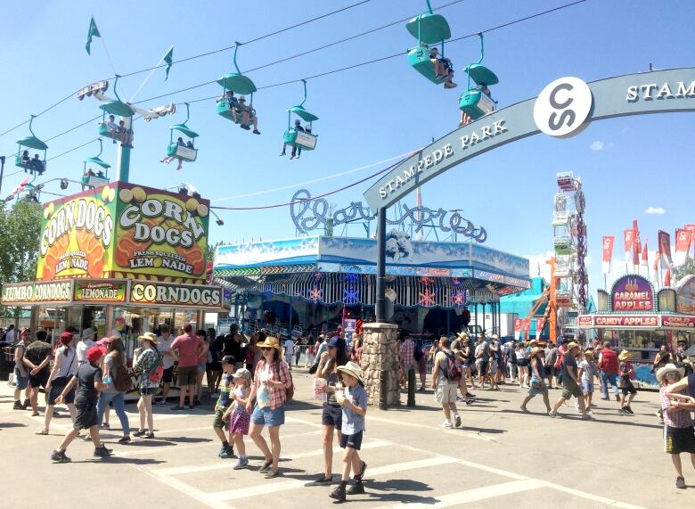 A busy crowd walking on the grounds of the Calgary Stampede.