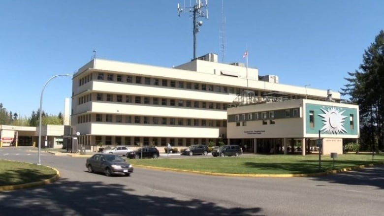 A squat white hospital building.