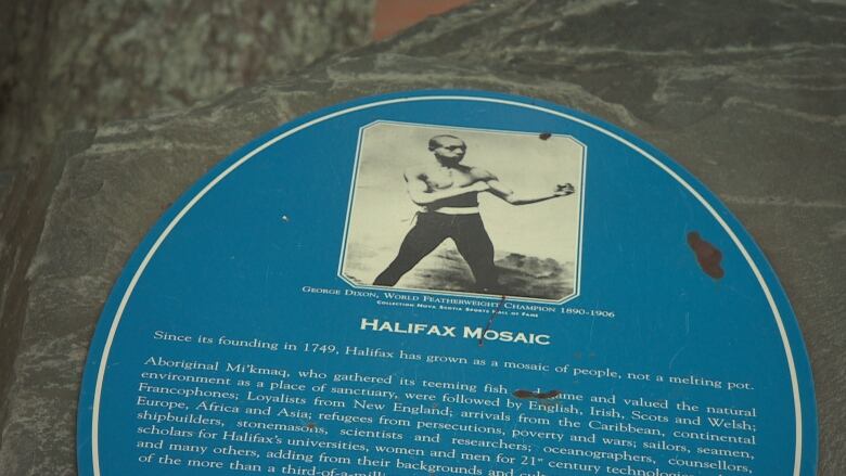 A plaque with an image of Black boxer on it and information about George Dixon