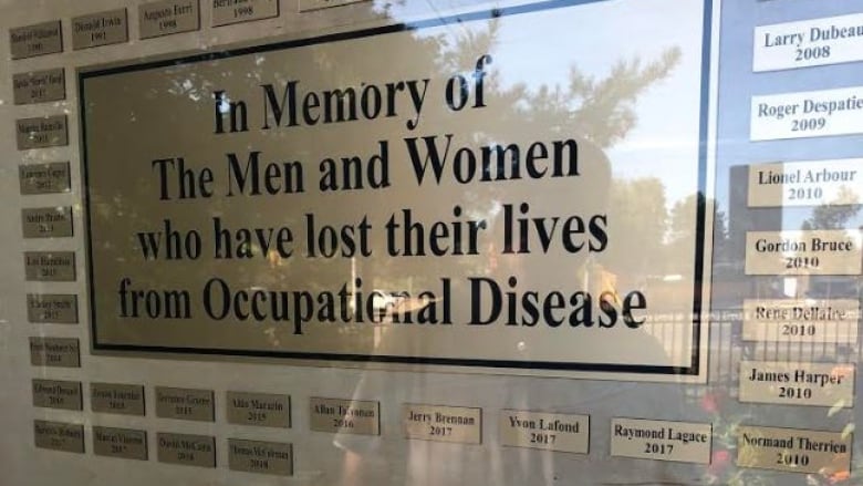 A sign saying, 'In Memory of the Men and Women who have lost their lives from Occupational Disease.' 