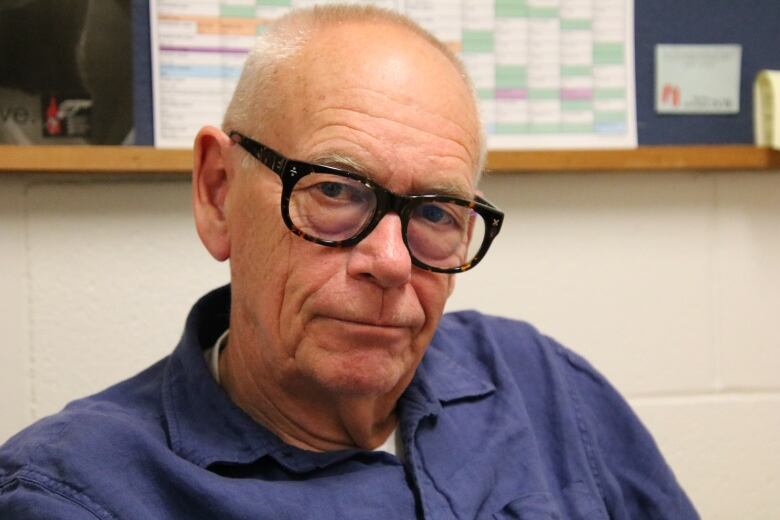 Close up of a man wearing glasses. 