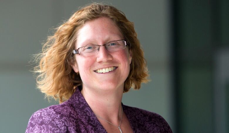 A woman smiles at the camera.