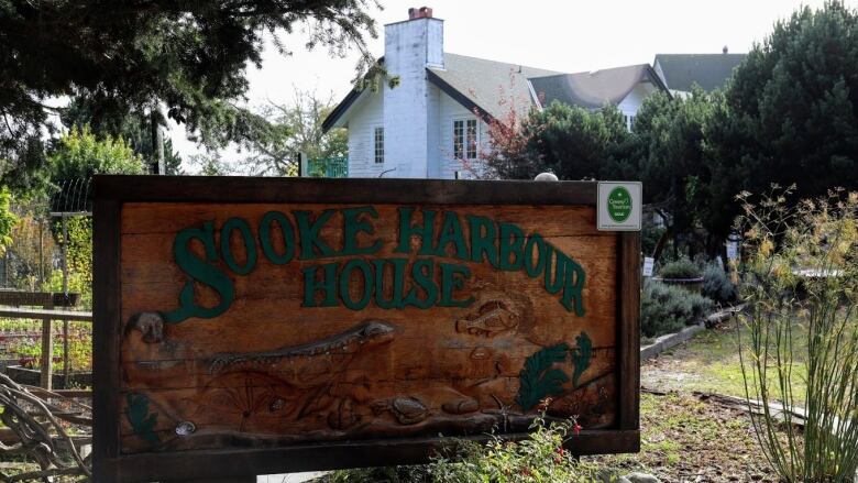 A wooden sign reading 'Sooke Harbour House'.