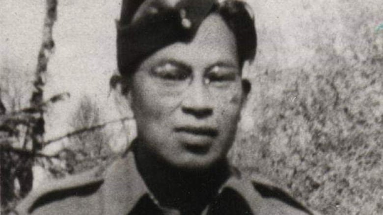 A black and white image of a young man wearing a military uniform