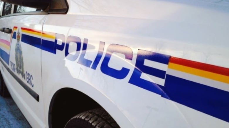 A close up of a car with Police stenciled on its side