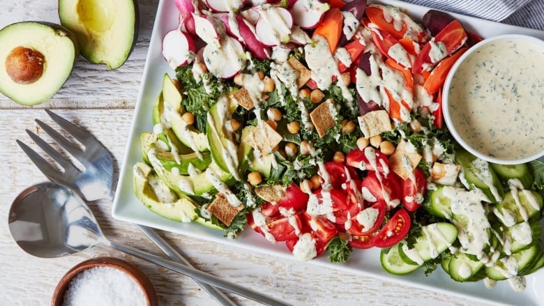 Overhead shot of a white serving platter of salad. 