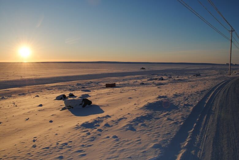 Sun over ice, snow.