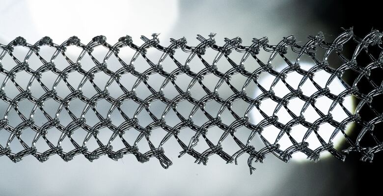 A close-up of surgical mesh with a broken section at the bottom.