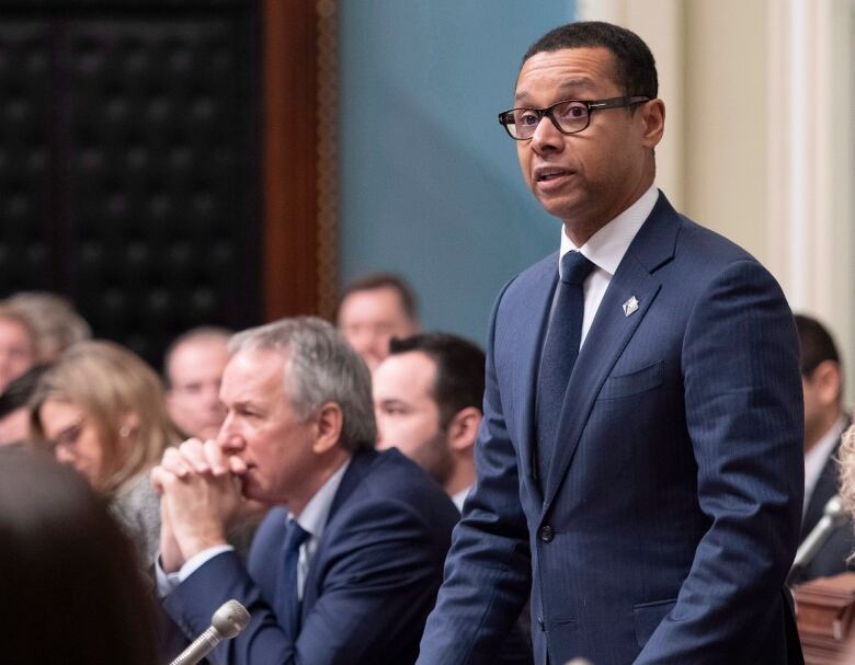 A man stands in Quebec's National Assembly. 