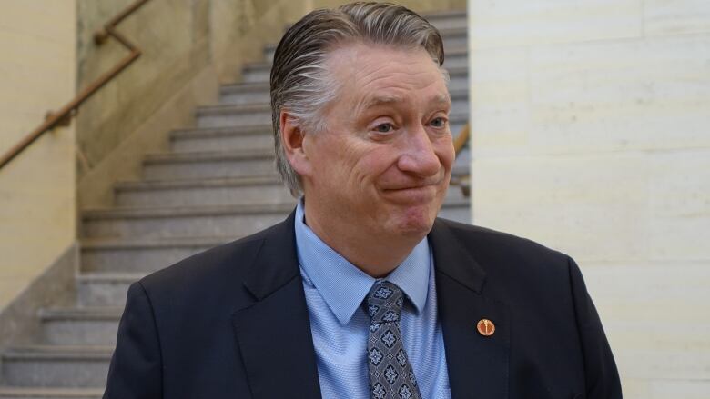 A man is shown wearing a suit and tie.