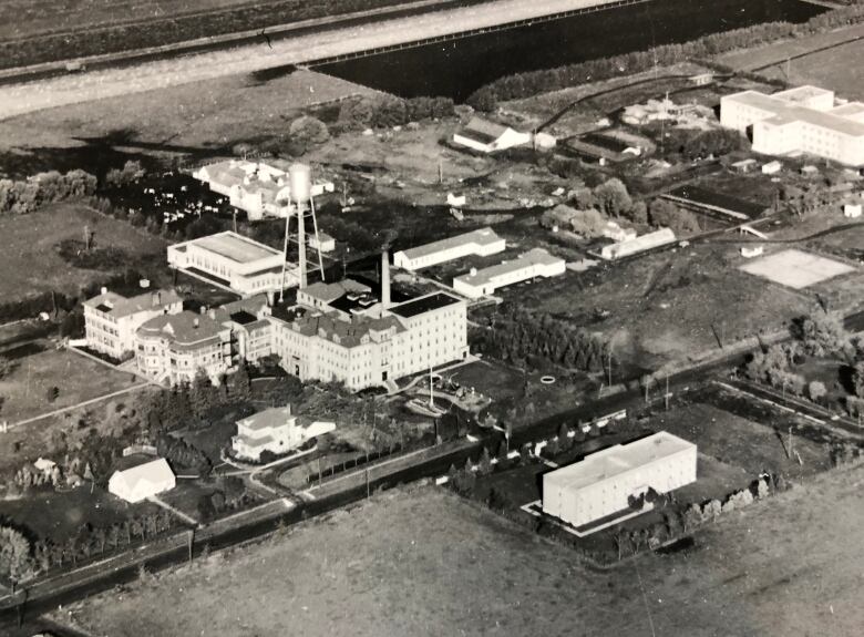 Black-and-white aerial photo of several buildings.