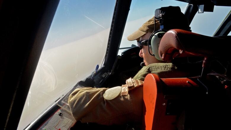 A Canadian CP-140 Aurora pilot looks over the Libyan coast during a surveillance mission on July 25, 2011. Aurora surveillance planes recently started broadcasting propaganda messages aimed at convincing forces loyal to dictator Moammar Gadhafi to give up and go home.