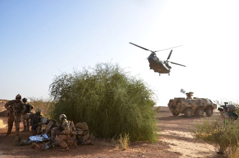 A military helicopter comes in for a landing.