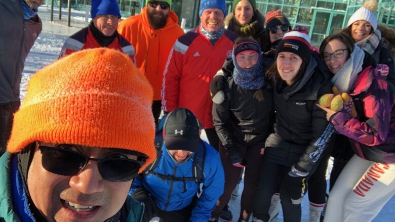 Runners in winter gear posing for a photo in a group