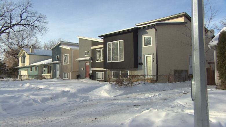 A row of houses is shown in winter.