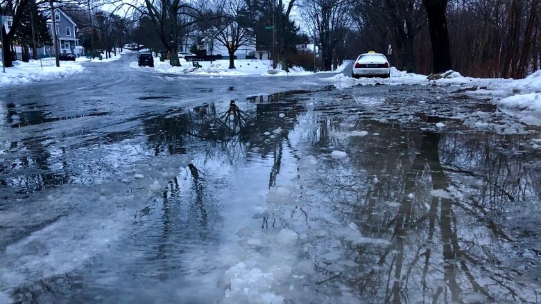 Water, slush and snow on a messy street.