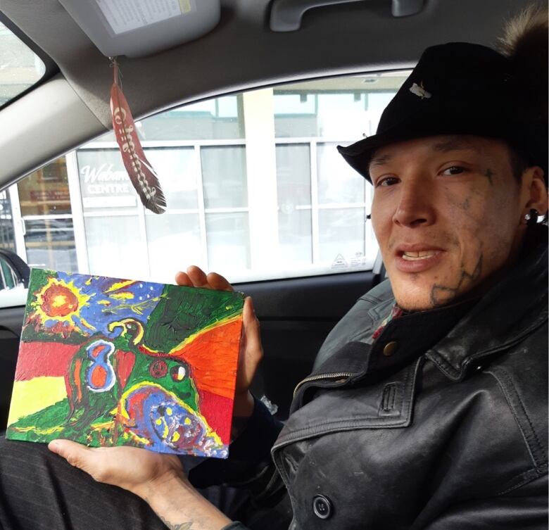 A close-up photo of a man sitting in a car.