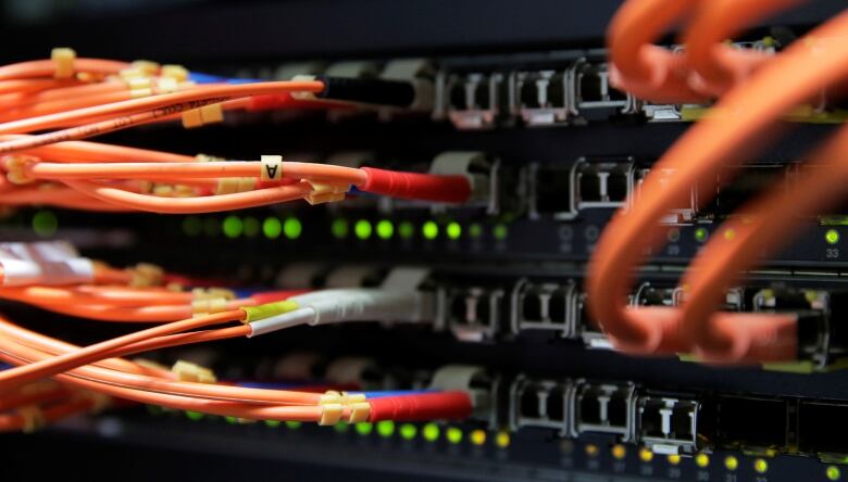 Computer network equipment, including orange cords, in a server room in Vienna, Austria, October 25, 2018.