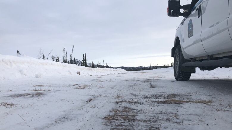 A vehicle is seen stopped on a snow-covered road.