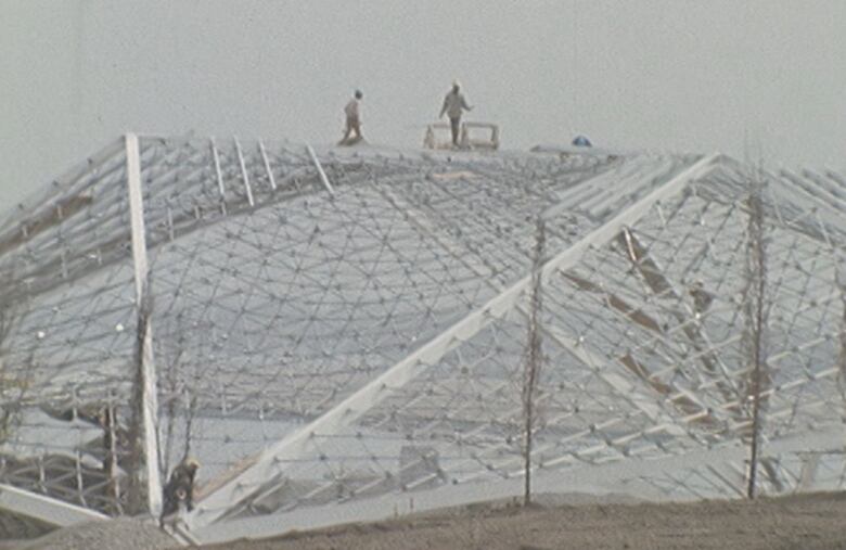 construction workers building roof of theatre