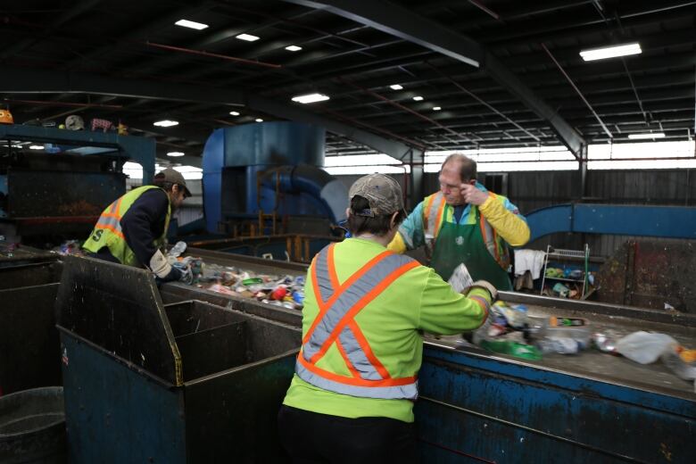 Workers at the EWSWA's container plant sorting items on April 10th, 2019. Items at this facility go through an optical sorter first, then are handled by humans.