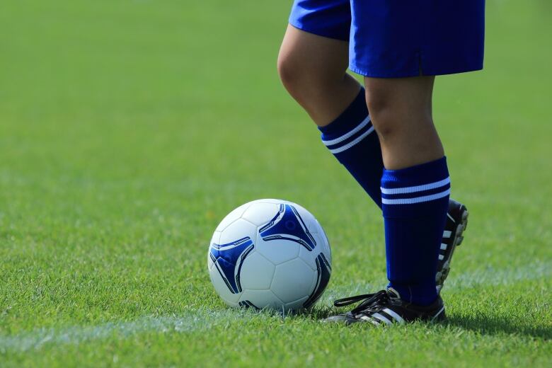 A person about to kick a soccer ball. 