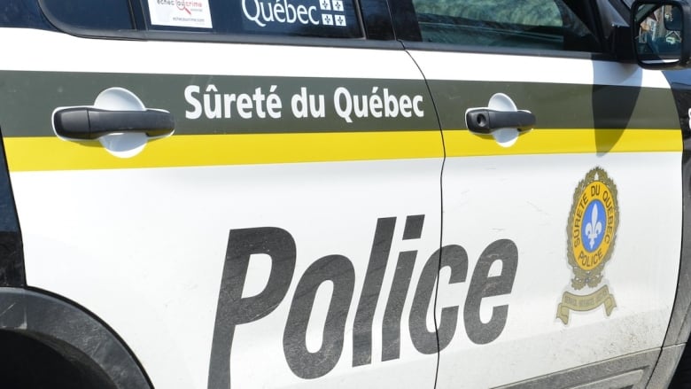 Quebec provincial police logo on police cruiser.