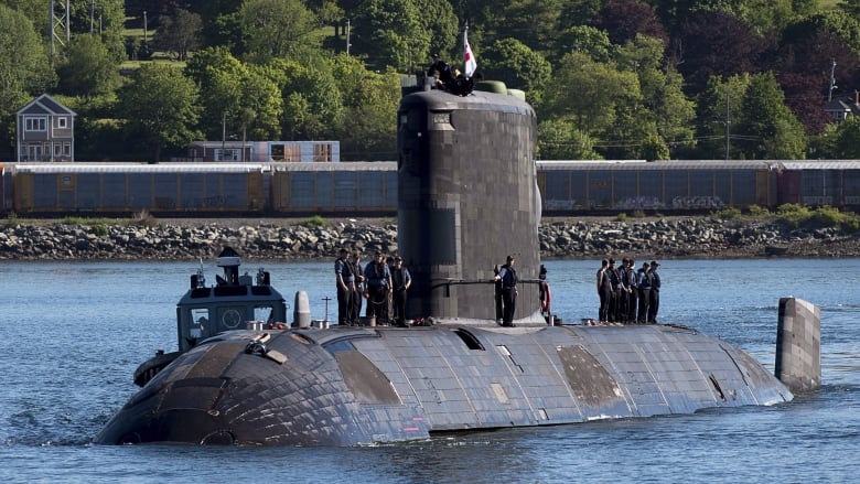 A submarine returns to port.