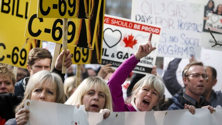 Protestors wave signs