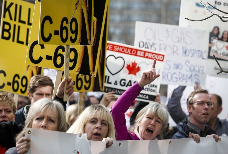 Protestors wave signs