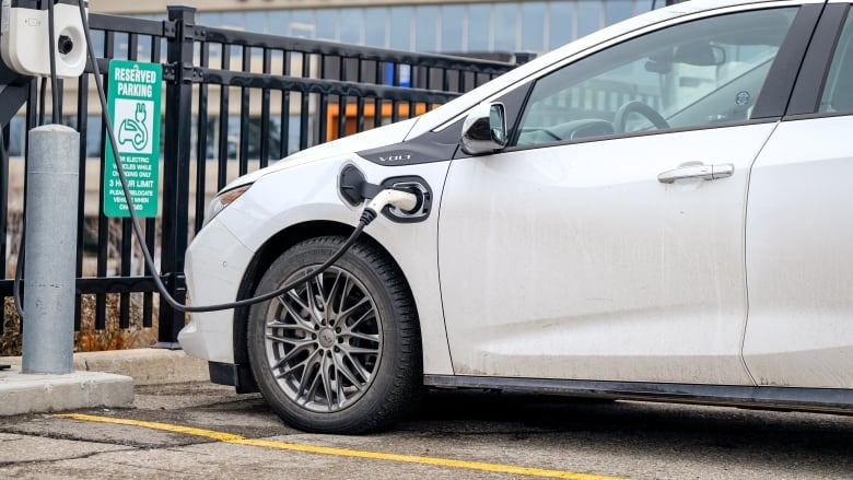 Hybrid 2018 Volt cars at electric vehicle charging stations in the GM lot.