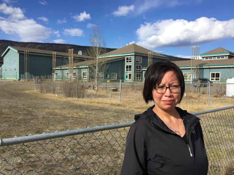 A woman standing infront of a building