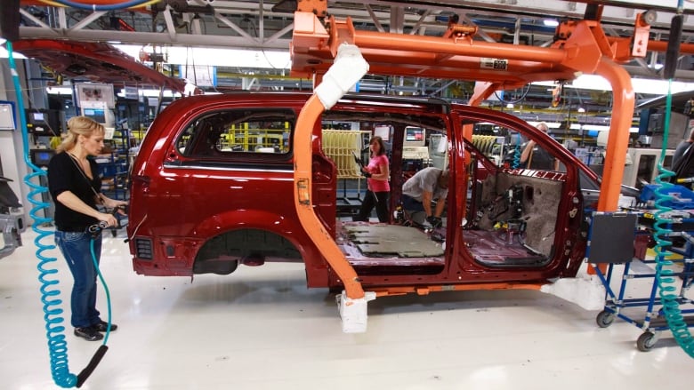 Workers on the production line at Chrysler's assembly plant in Windsor, Ont., work on one of their new minivans on January 18, 2011. A second round of auto worker layoffs in recent months has led politicians to jump to assure workers as the automotive sector undergoes significant transformation. THE CANADIAN PRESS/Geoff Robins