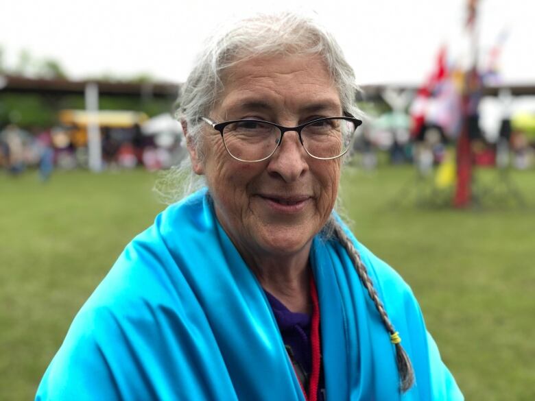 Marjorie Beaucage stands outside.